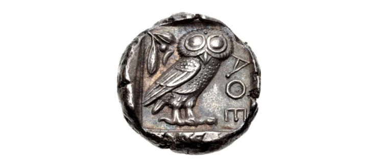 metal coin with an owl